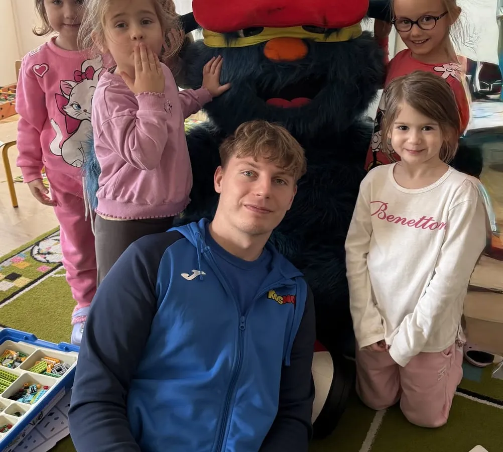Zajęcia sportowe — trener z dziećmi i maskotką w przedszkolu